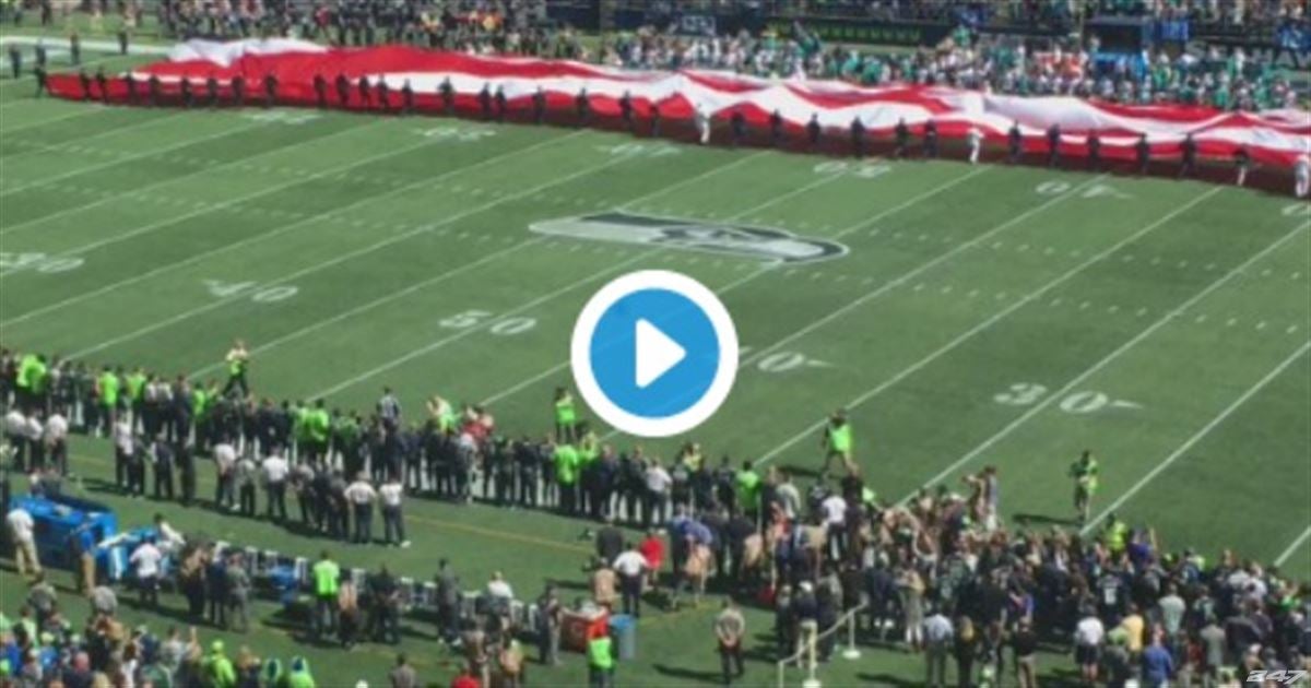 The Seattle Seahawks link arms during national anthem