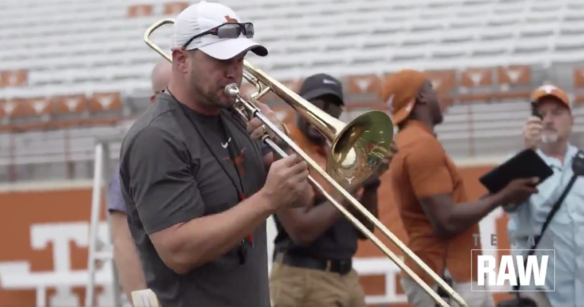 Tom Herman tests trombone skills after recognizing Longhorn Band