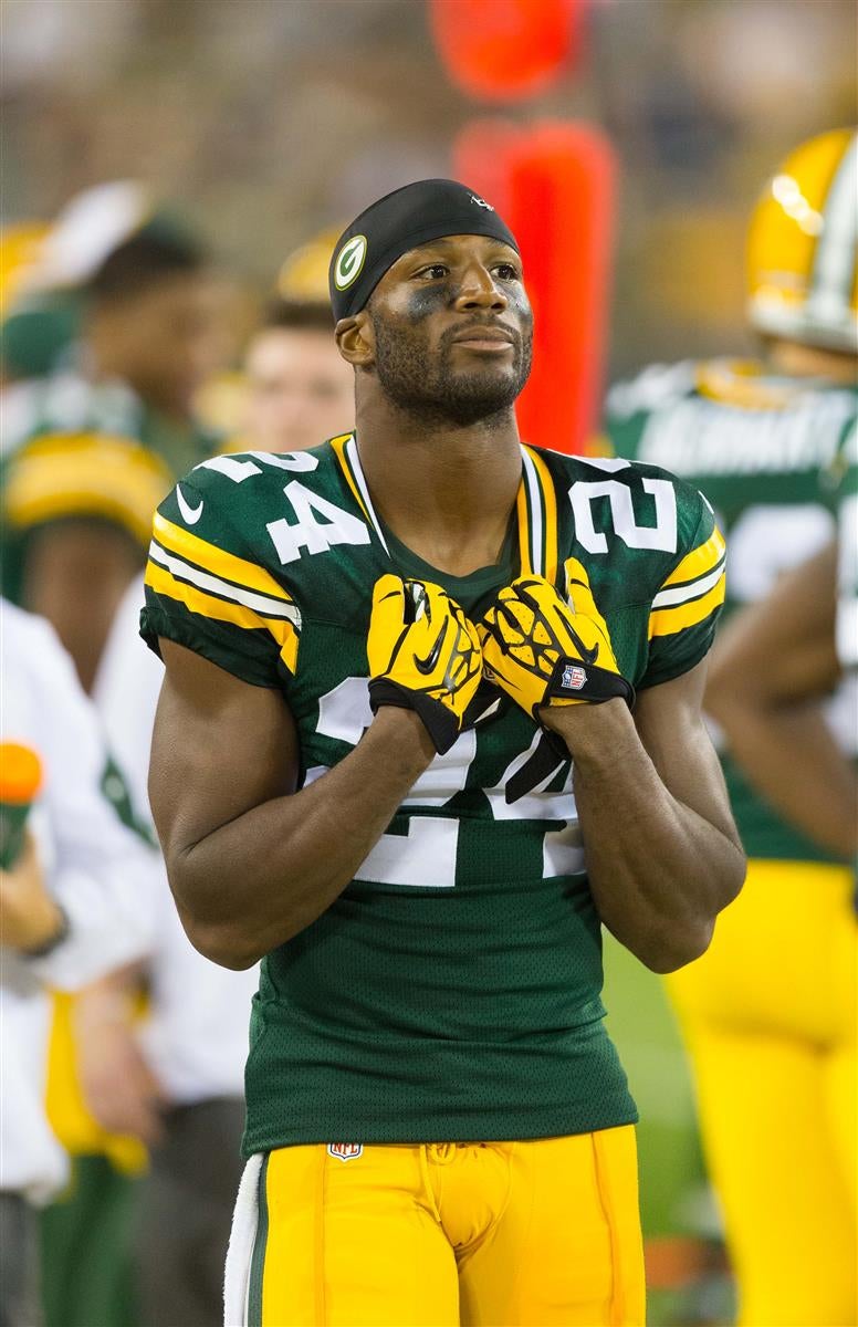 Green Bay Packers special teams player Jarrett Bush (R) trips up