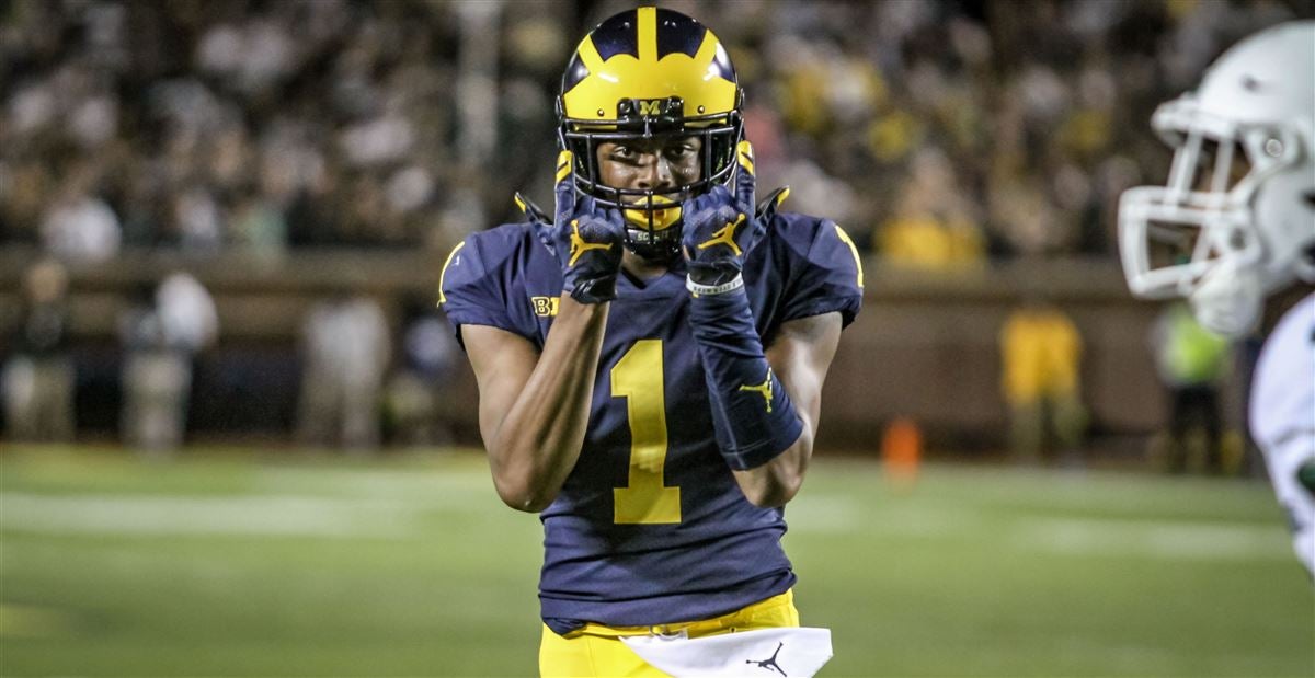 Michigan defensive back Ambry Thomas (1) tries to rip the ball