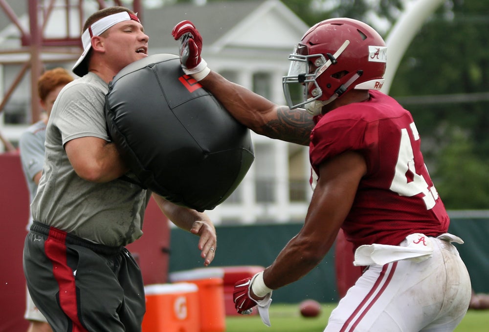 Najee Harris pushing his way up the stiff-arm ladder 