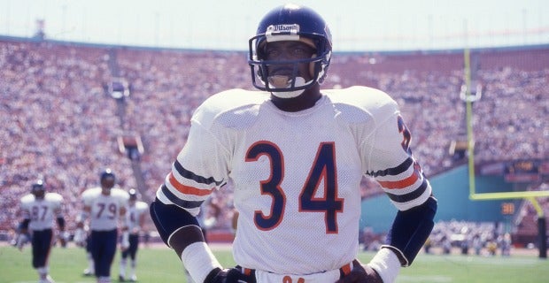 Chicago Bears' Walter Payton (34) comes in for a landing on top of