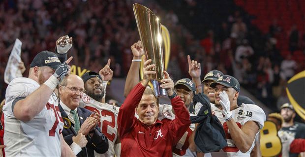 Tua Tagovailoa Alabama Crimson Tide Unsigned White Jersey Raising Up National Championship Trophy Photograph