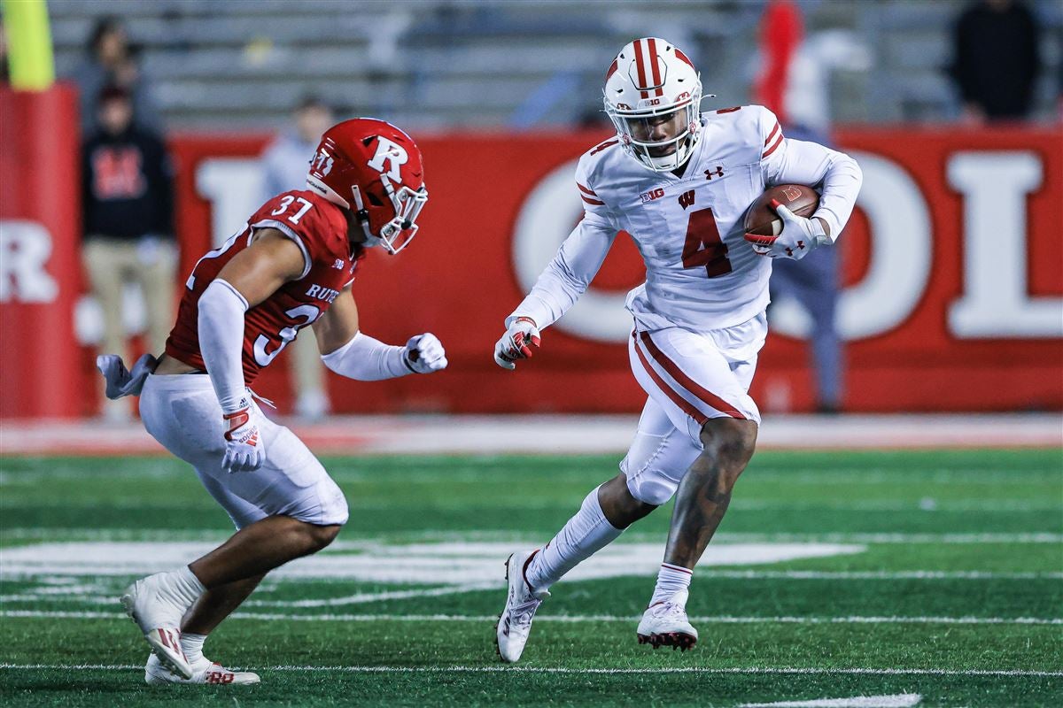 Nov 6, 2021; Piscataway, New Jersey, USA; Wisconsin Badgers wide receiver Markus Allen (4) gains yards after the catch as Rutgers Scarlet Knights defensive back Joe Lusardi (37) pursues during the second half at SHI Stadium. Mandatory Credit: Vincent Carchietta-USA TODAY Sports
