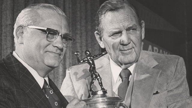 Coach Paul Bryant, second from left, gives affectionate hugs to his three  big offensive players in the Kentucky Wildcats victory over Texas Christian  University in the Cotton Bowl Game Jan. 1, 1952