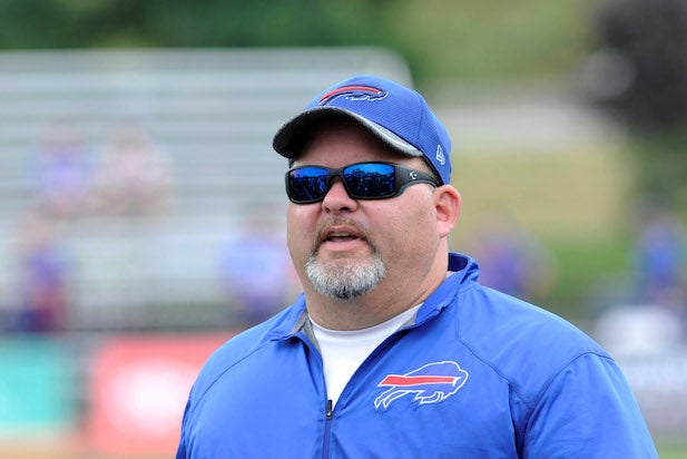 Baltimore Ravens offensive coordinator Greg Roman, center, talks