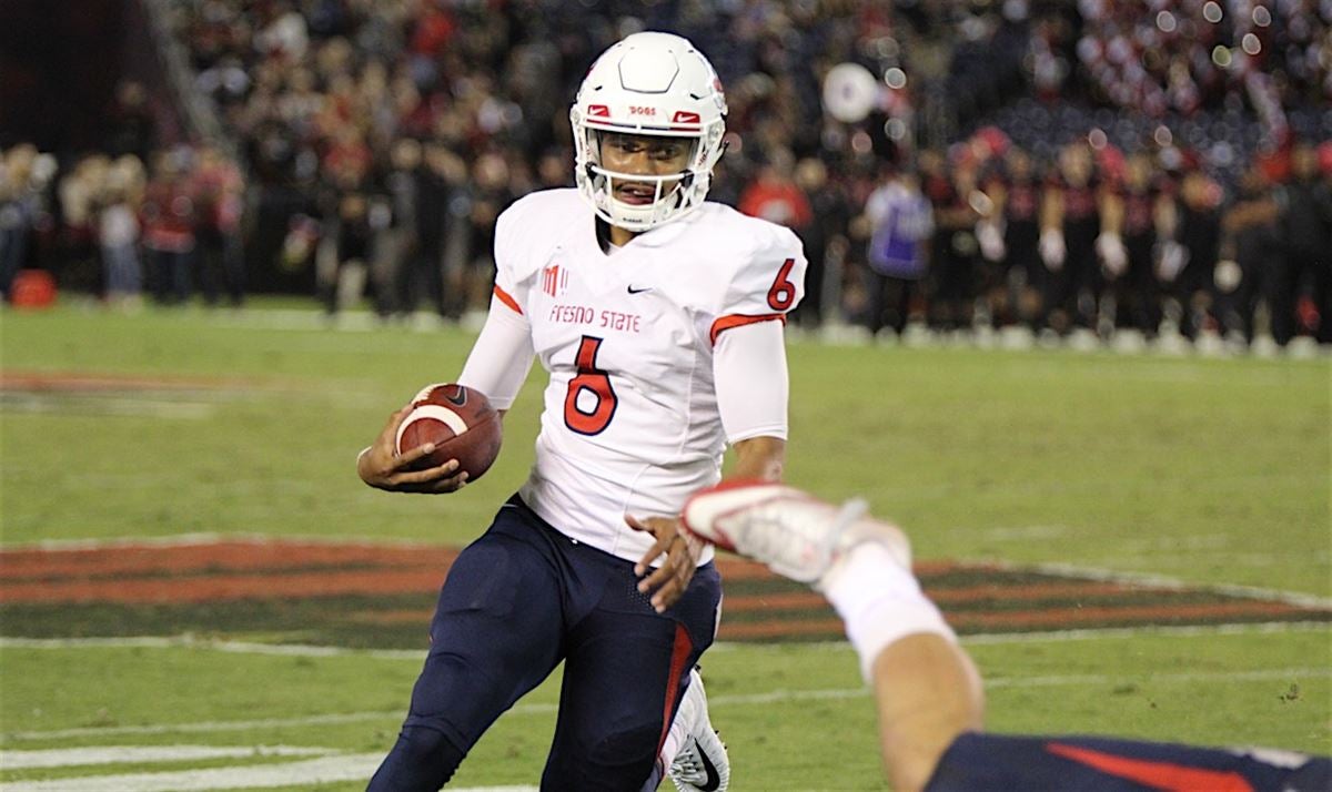 Fresno State quarterback Marcus McMaryion raises the trophy in celebration  of his team's win ov …