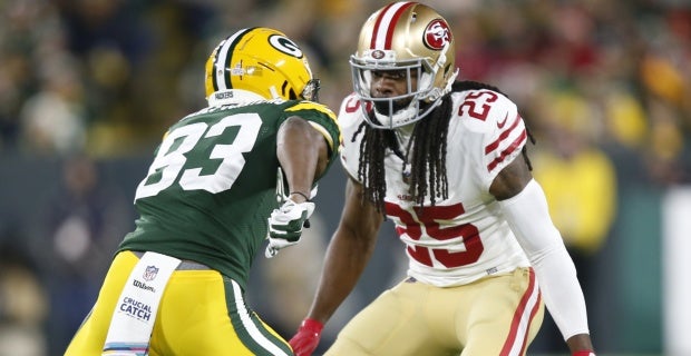 Green Bay Packers running back Aaron Jones (33) runs in front of San  Francisco 49ers cornerback Richard Sherman (25) and strong safety Jaquiski  Tartt (29) during the NFL football NFC Championship game