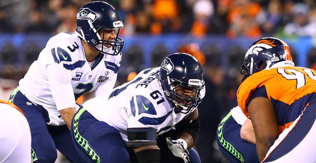 Don Jerry (blue shirt) and two other Seattle Seahawk fans flap their arms  like bird wings after the Seattle Seahawks win the National Football  League's championship game after defeating the Denver Broncos