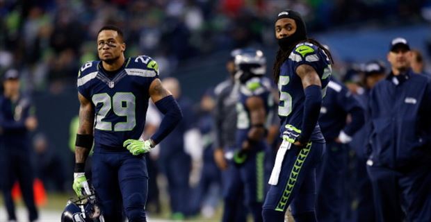 San Francisco 49ers cornerback Richard Sherman (25) is greeted by teammates  after Sherman inter …