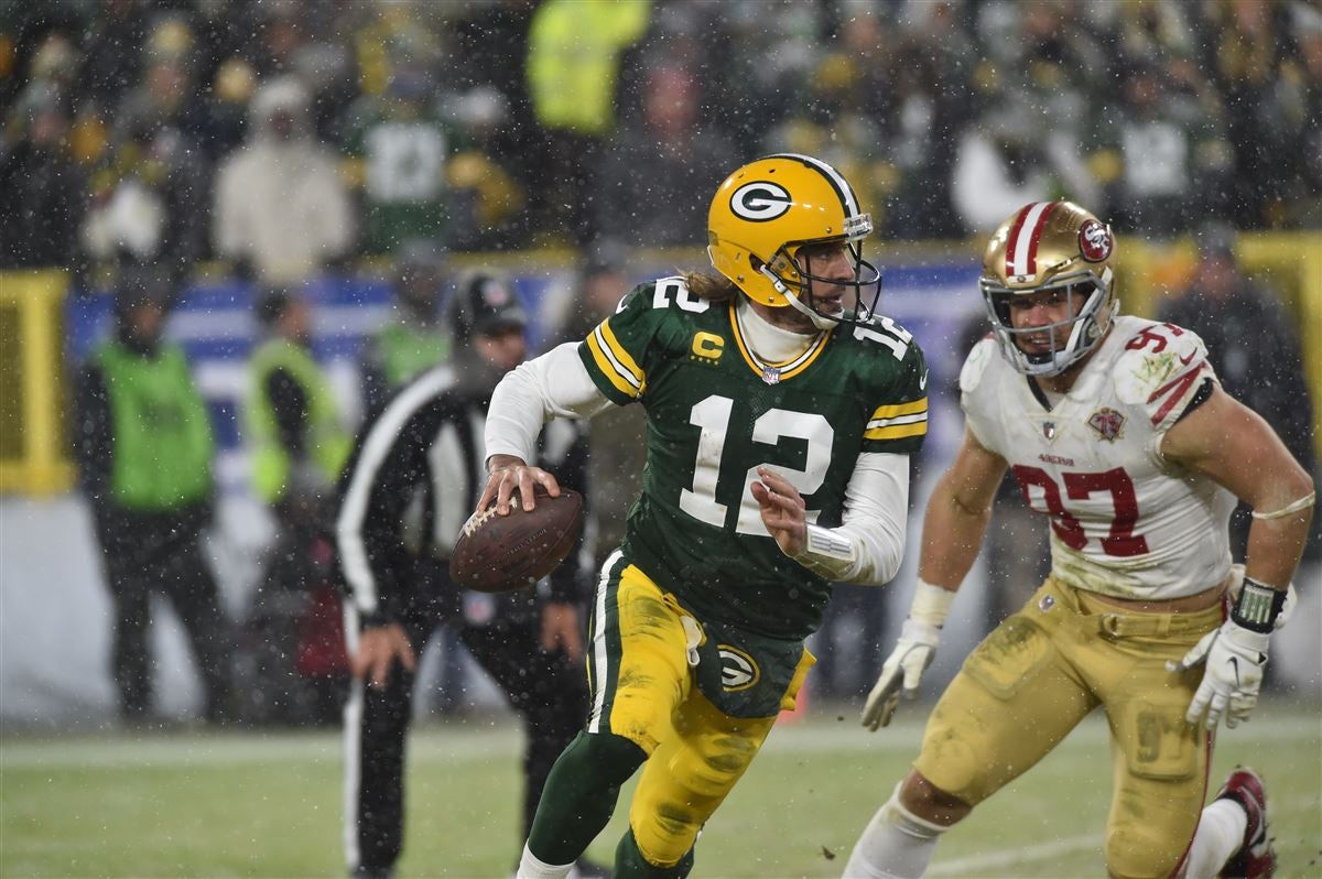 Jan 22, 2022; Green Bay, Wisconsin, USA; Green Bay Packers quarterback Aaron Rodgers (12) and San Francisco 49ers defensive end Nick Bosa (97) in action during a NFC Divisional playoff football game at Lambeau Field. Mandatory Credit: Jeffrey Becker-USA TODAY Sports
