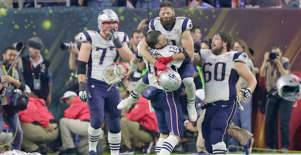 New England Patriots quarterback Tom Brady greets Seattle Seahawks  quarterback Russell Wilson (L) as Patriots owner Robert Kraft (C) looks on  after the Patriots defeated the Seahawks in the NFL Su …