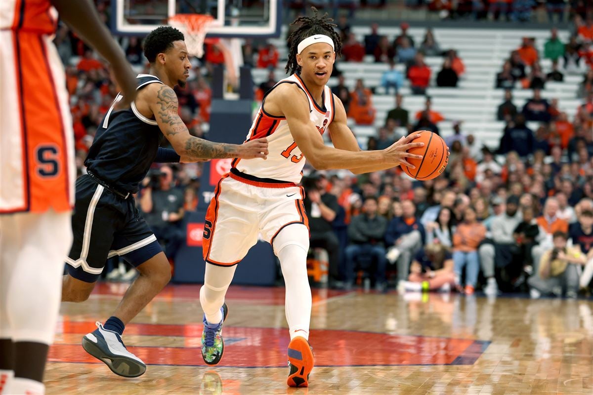 Syracuse forward Benny Williams, right, grabs a rebound in front