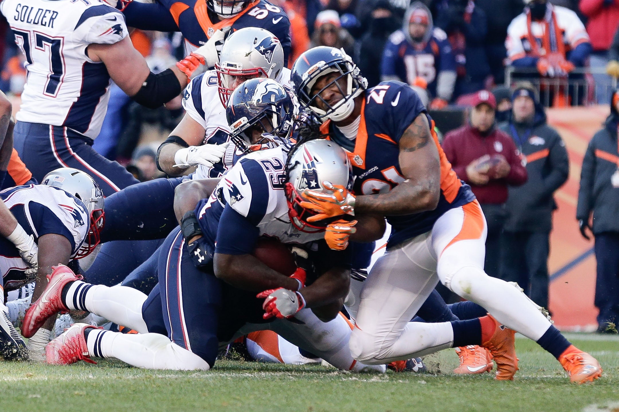 New England Patriots quarterback Tom Brady (12) sails after being hit by Denver  Broncos cornerback Aqib Talib on a first down run in the second quarter  during the AFC Championship game at