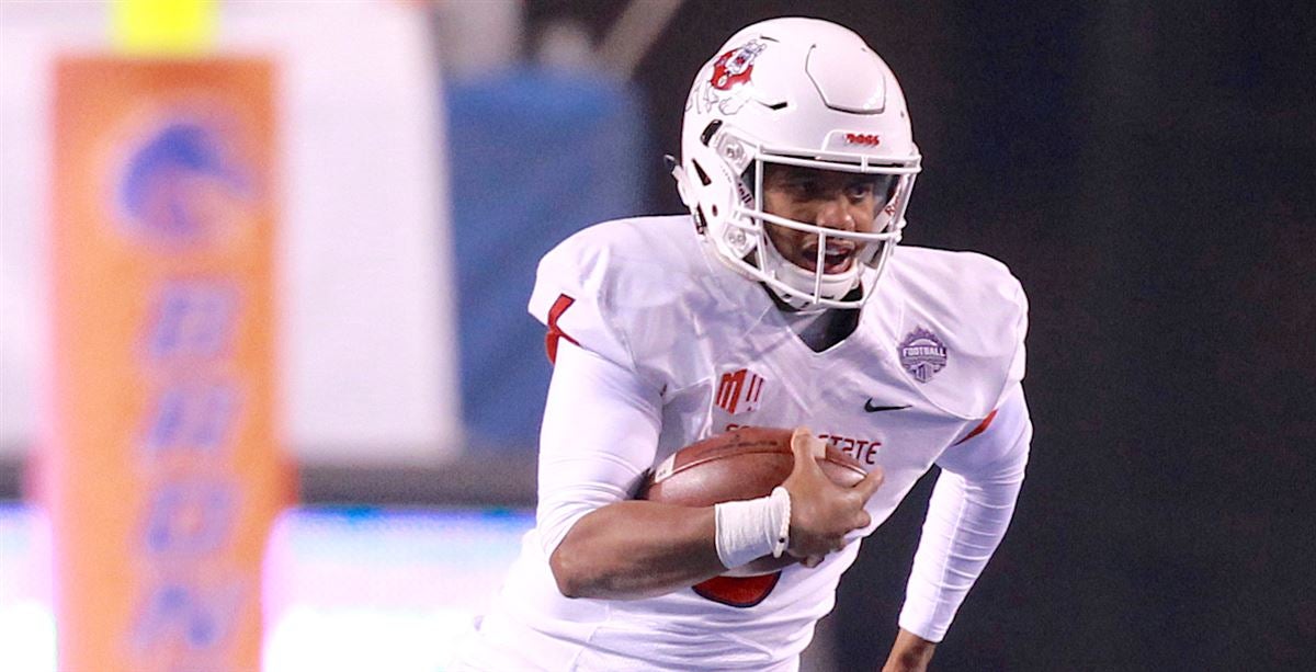 Fresno State quarterback Marcus McMaryion raises the trophy in celebration  of his team's win ov …