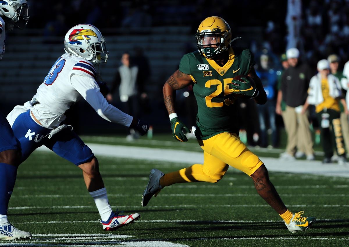 Baylor running back Trestan Ebner (1) leaps over TCU placekicker