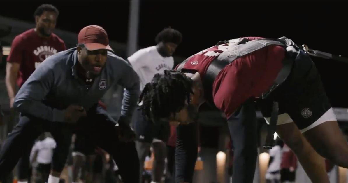 Teammates and coaches pressure the Gamecocks All-SEC defender to end a workout