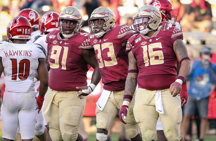 Florida State's defensive line gathering at the line of scrimmage 