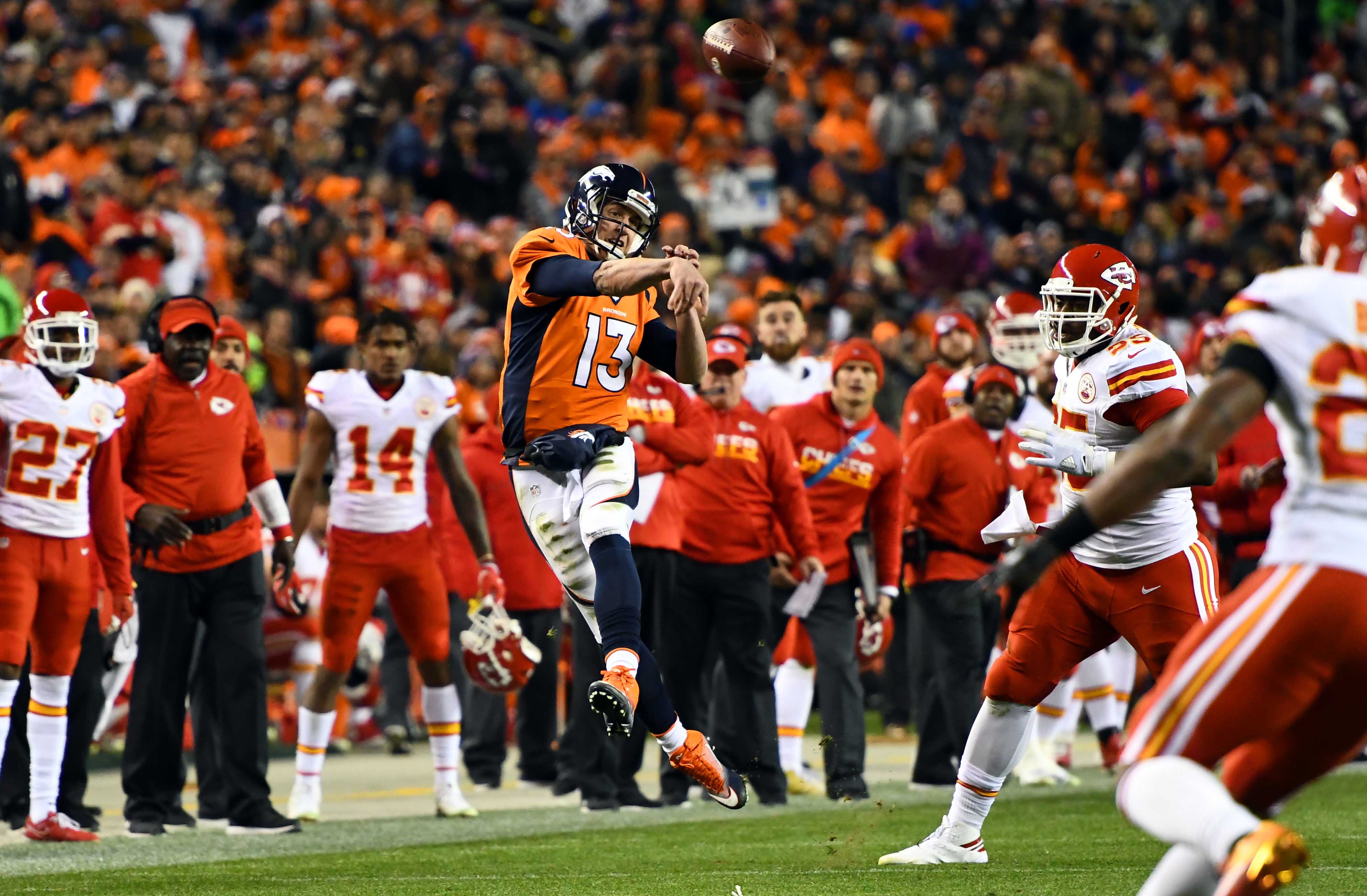 Kansas City Chiefs offensive coordinator Eric Bieniemy talks to Chiefs  tight end Travis Kelce (87) after their win over the Buffalo Bills in an  NFL divisional playoff football game, Sunday, Jan. 23