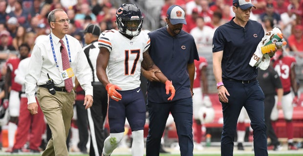 Washington Commanders running back Brian Robinson Jr. runs in for touchdown  over Chicago Bears defensive lineman Armon Watts in the second half of an  NFL football game in Chicago, Thursday, Oct. 13