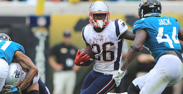 New England Patriots running back Sony Michel (26) tries to break free from  Las Vegas Raiders d …