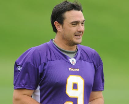 Minnesota Vikings kicker Rhys Lloyd struggles to put on his helmet