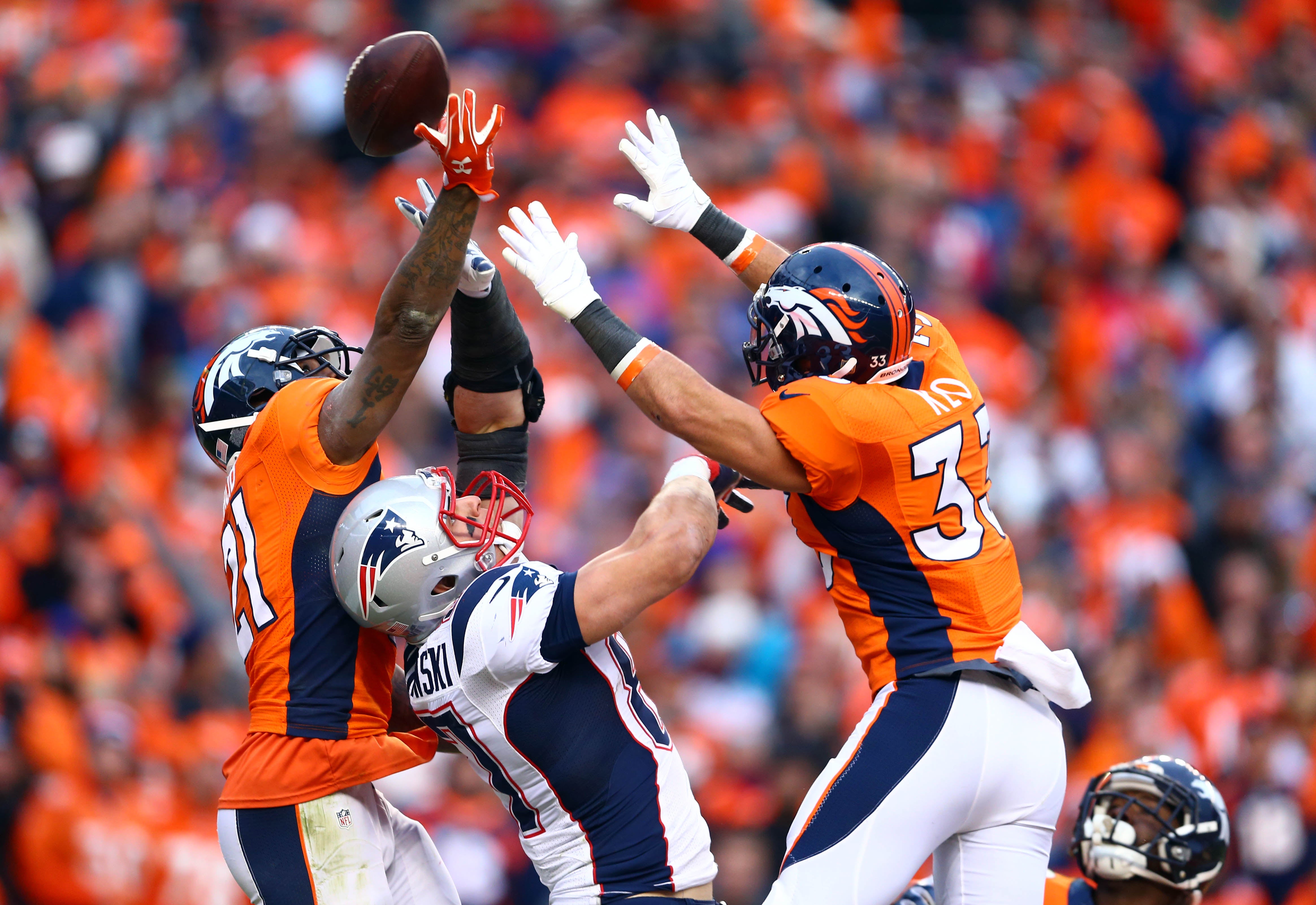 New England Patriots quarterback Tom Brady (12) sails after being hit by Denver  Broncos cornerback Aqib Talib on a first down run in the second quarter  during the AFC Championship game at