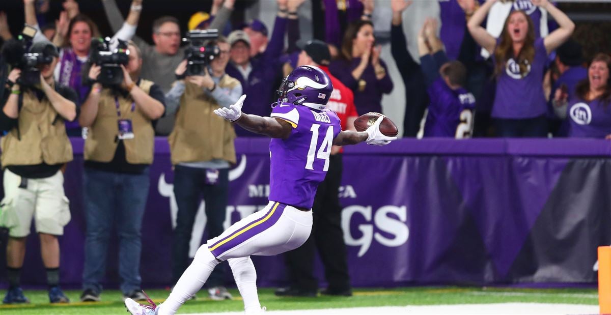 Washington Redskins quarterback Robert Griffin III (10) sprints down the  sideline for a touchdown as Minnesota Vikings free safety Harrison Smith  (22) makes a diving attempt to tackle him during the second