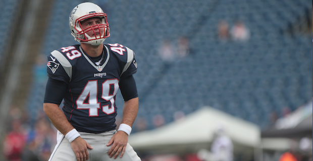 Tampa Bay Buccaneers quarterback Tom Brady (12) meets with New England  Patriots long snapper Jo …