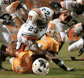 Ronnie Brown, center, a running back from Auburn, is joined by