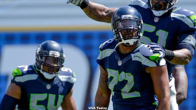 Michael Bennett, all Seahawks, stand for the national anthem on Salute to  Service night vs. Atlanta