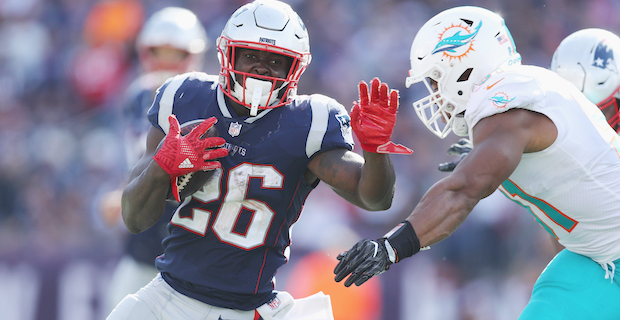 New England Patriots running back Sony Michel (26) tries to break free from  Las Vegas Raiders d …