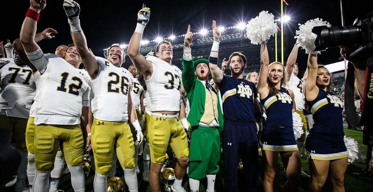 Notre Dame quarterback Ian Book and Liam Eichenberg celebrate a