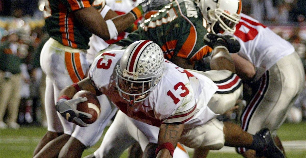 Running back Maurice Clarett smiles as he holds up a Denver