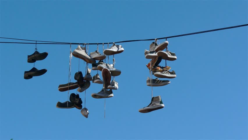 sneakers hanging on power lines /streetlamps