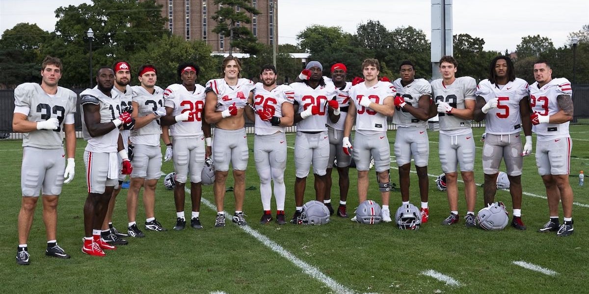 Two Buckeyes have their black stripes removed before the Iowa game
