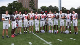 Two Buckeyes have their black stripes removed before the Iowa game