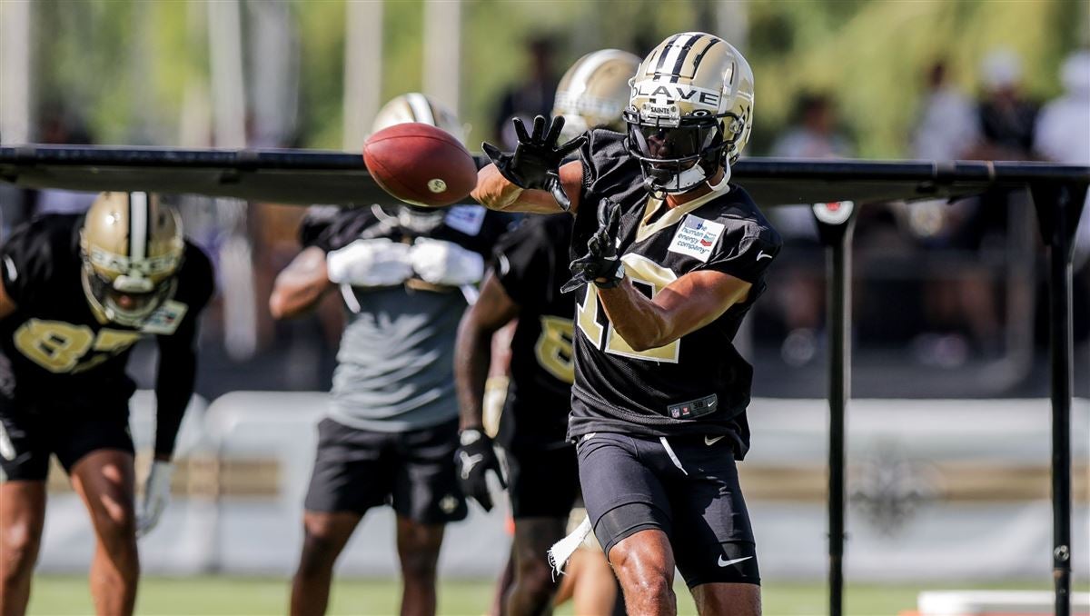 New Orleans Saints first round draft pick, wide receiver Chris Olave (12),  high fives quarterback Jameis