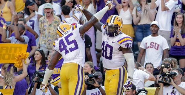 Former LSU head football coach, Ed Orgeron, right, talks to his girlfriend  Bailie Lauderdale during the third quarter of an NCAA college football game  between Texas A&M and Miami on Saturday, Sept.