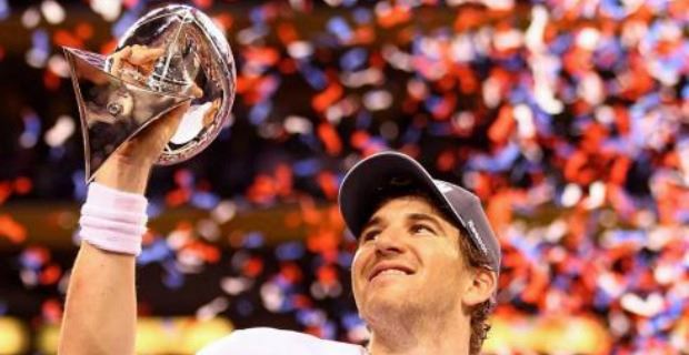 New York Giants quarterback Eli Manning raises his hands in the air after  throwing his first career touchdown pass. The Atlanta Falcons defeated the  New York Giants 14 to 7 at Giants