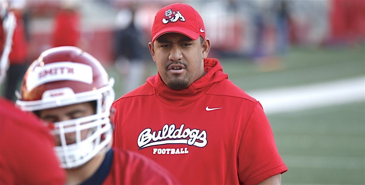 Hawaii offensive line coach and new co-offensive coordinator Roman Sapolu  growing into new role