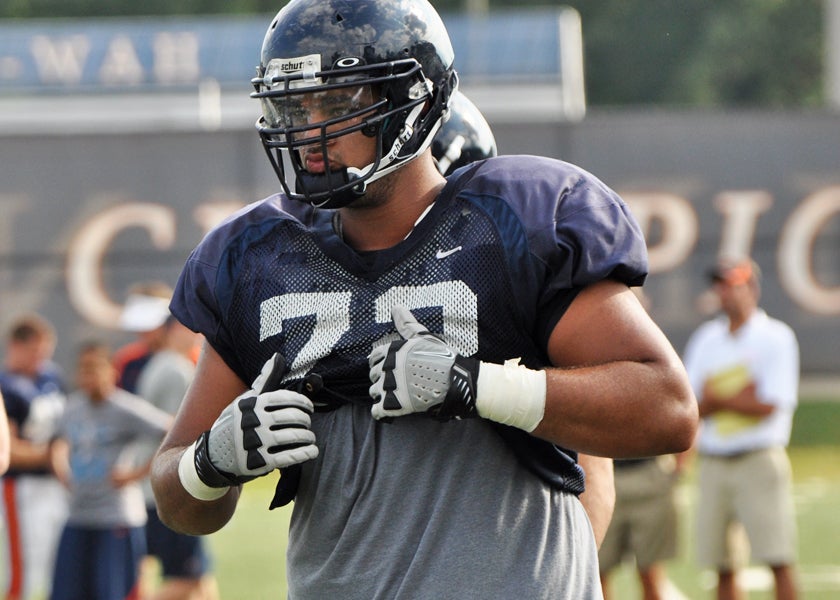 Virginia offensive tackle Oday Aboushi (72) leads Virginia running