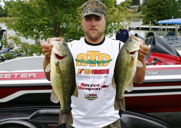 Rich Lindgren holding up two bass from the tournament he was disqualified from for Tweeting on Twitter.