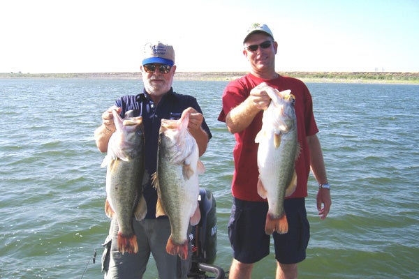 Charlie Haralson and Client hold up big bass from Falcon Lake